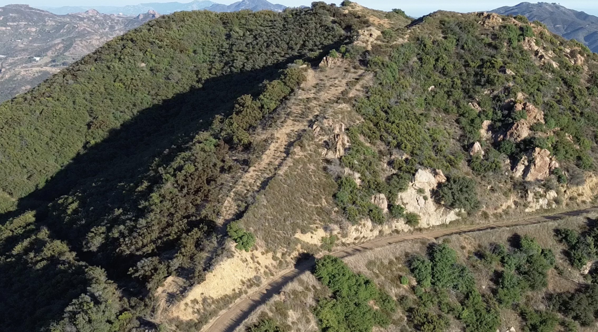 Close aerial view across the mountain terrain